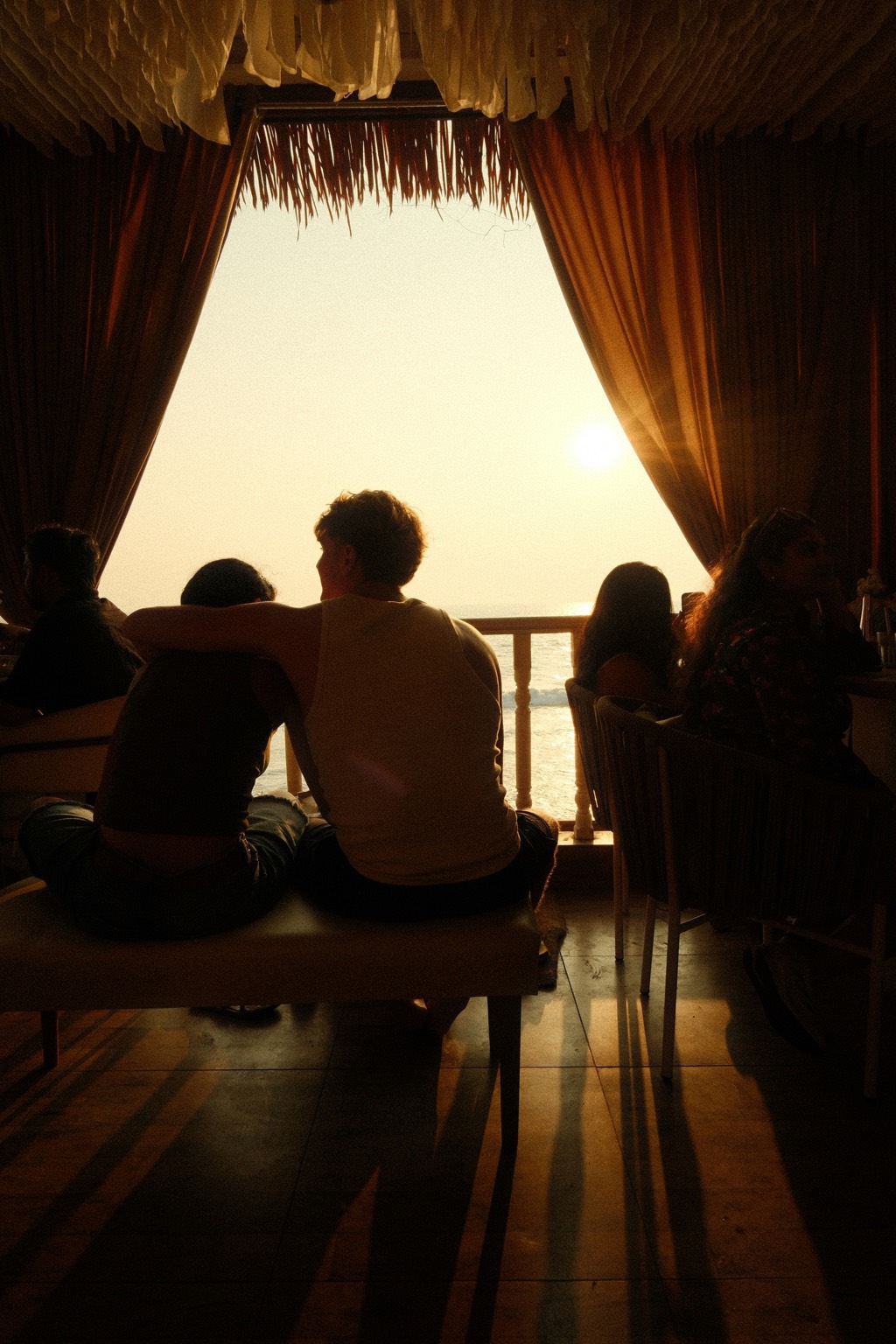 Silhouettes at the window during golden hour.