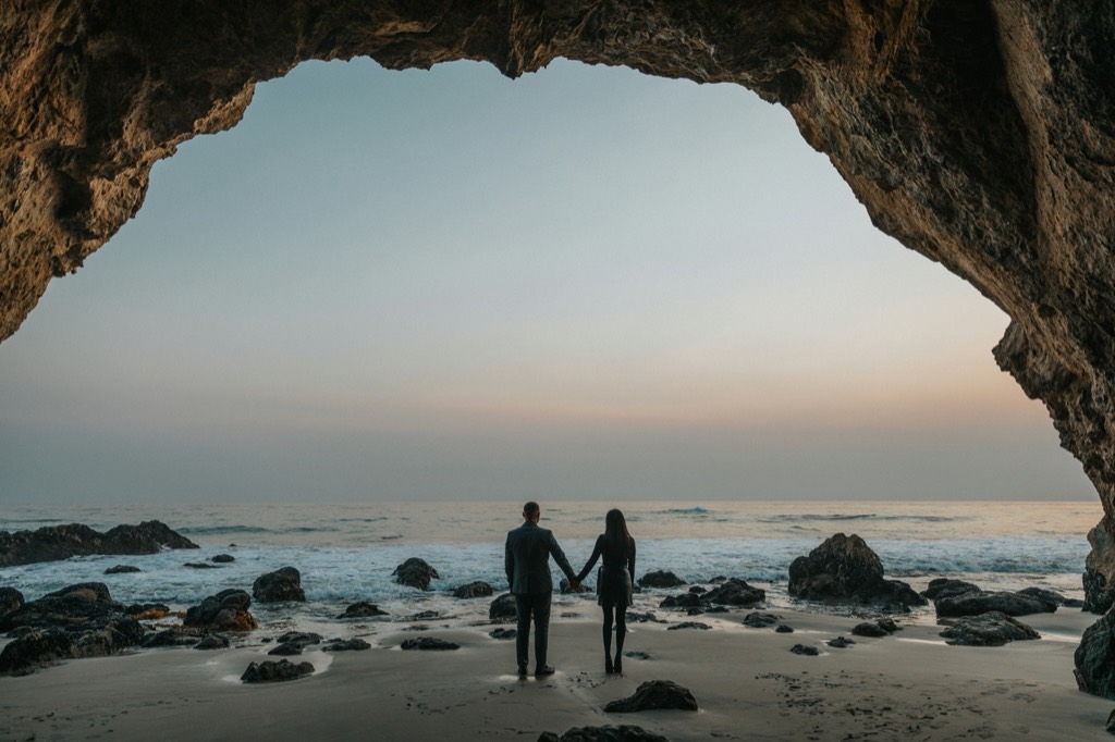 A couple at the beach at dusk.