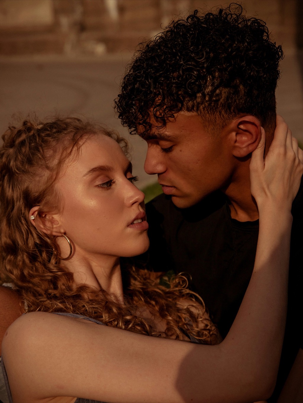 A couple close, in warm light.
