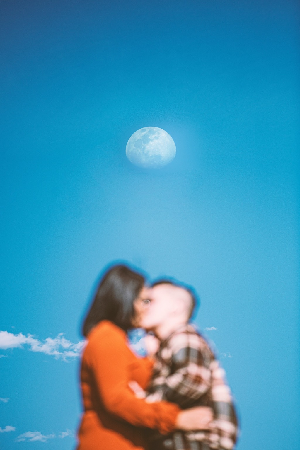 A kiss framed by the sun.